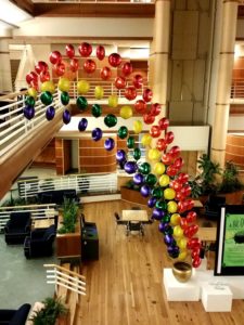 rainbow balloon decoration from balcony to floor