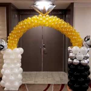 Do you need a special themed balloon arch for your entrance? Let us make a custom arch like this bride and groom ring arch to greet all your guests.