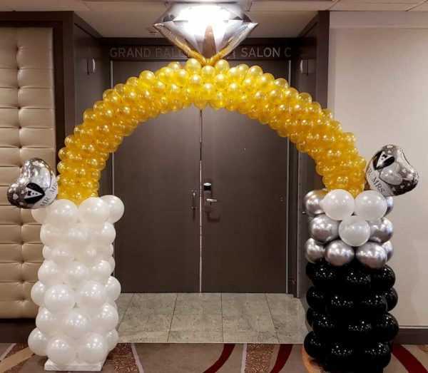 Do you need a special themed balloon arch for your entrance? Let us make a custom arch like this bride and groom ring arch to greet all your guests.